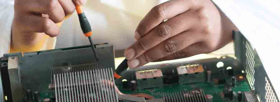 hands working on a circuit board